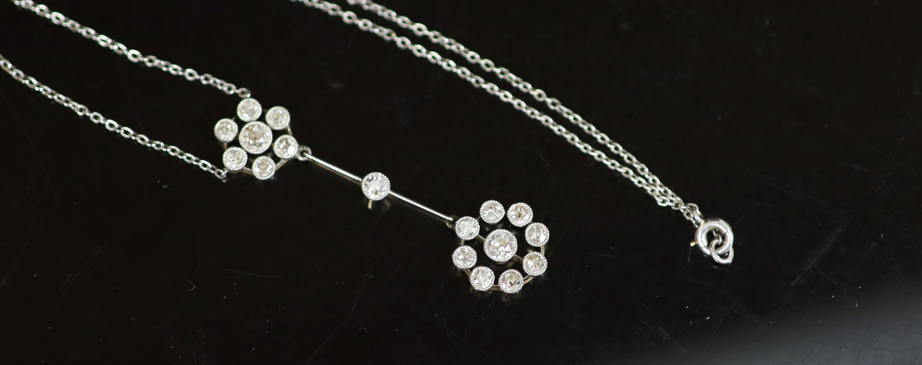 An early 20th century gold, platinum and millegrain set old round cut diamond double cluster drop pendant necklace